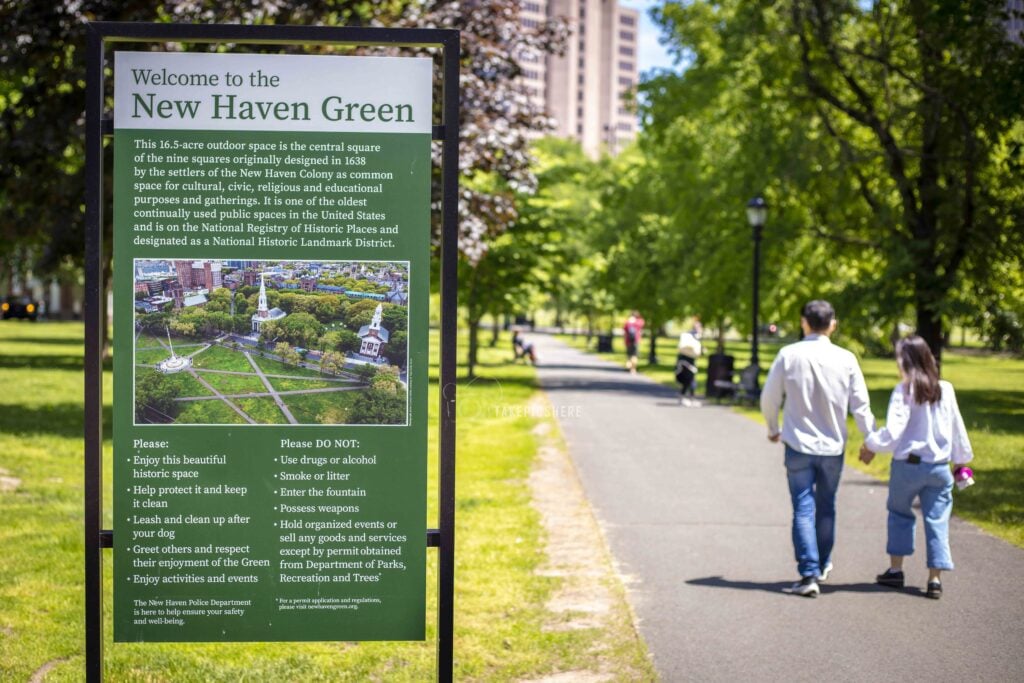 Welcome to New Haven Sign with Couple walking in BG. Photo Taken by Lance Long of LongShots Media