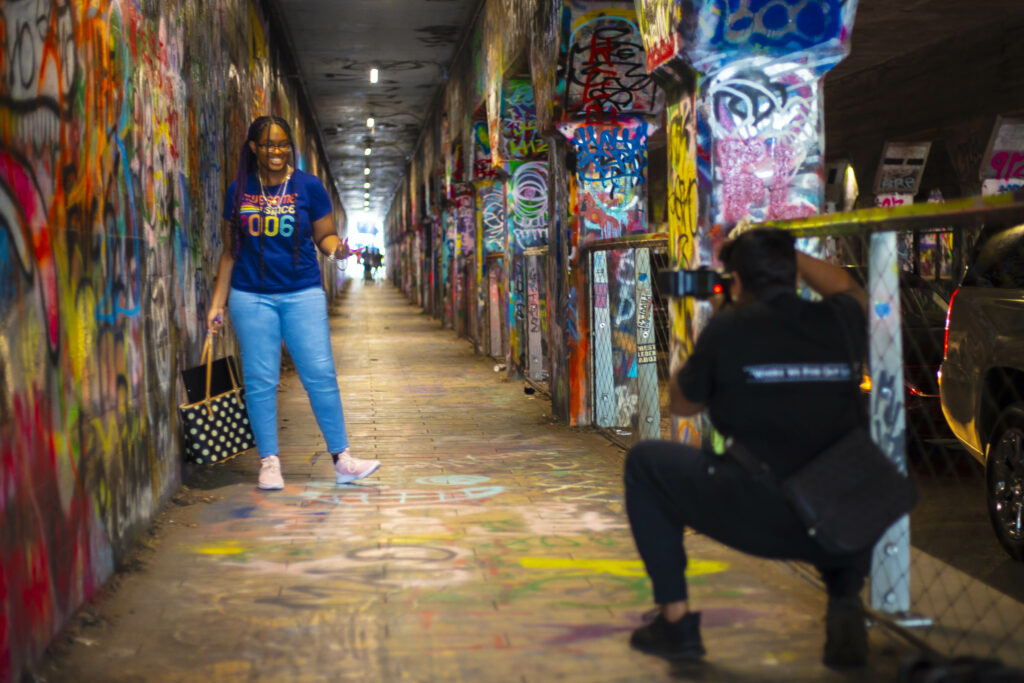 Miranda Malone of Life Print Photography photographing a client at Krog Street Tunnel in Atlanta Georgia. Photo taken by Lance Long of LongShots Media